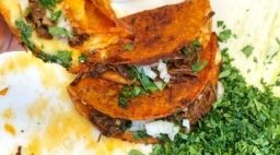Tacos garnished with cilantro.