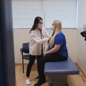 Julie Nguyen examines a patient.