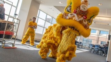 Lunar New Year dragon and dancer perform in The Commons.