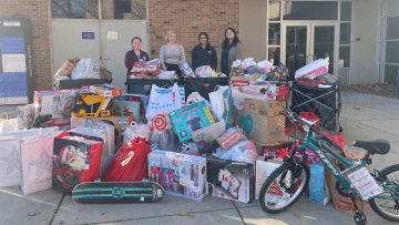 Members of the Student Services team gather holiday donations.