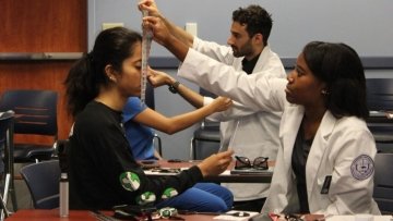 Optometry students check the vision of dental students.