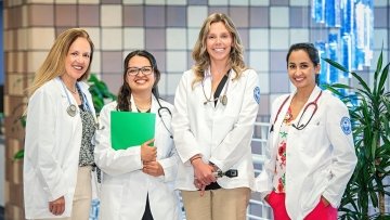 Group of four adult-gerontology nursing students and faculty.