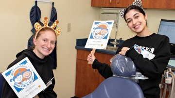 dental students with Give Kids a Smile banners