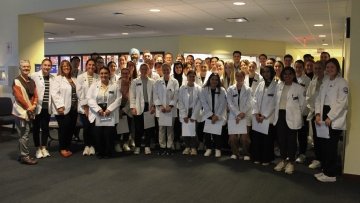 Large group of Physical Therapy students, faculty, and staff, prior to the interdisciplinary activity.