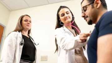 Doctor checks patient's heart