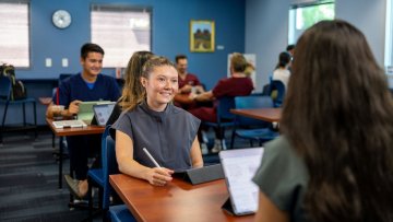 Two students sit at coffee shop