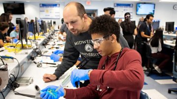 High school student working in the dental lab.