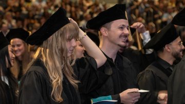 Midwestern University CHS graduates smile during the ceremony.
