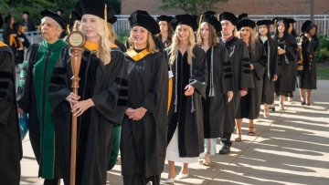 Graduates march across campus