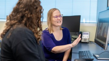 Speech language pathologist works with patient.