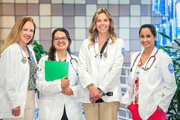 Group of four adult-gerontology nursing students and faculty.