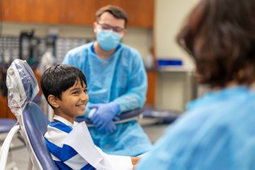 Child sits in dental chair awaiting treatment