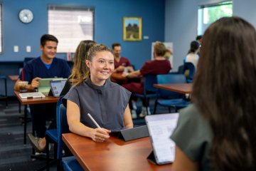 Two students sit at coffee shop