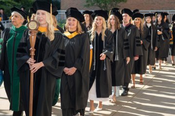 Graduates march across campus