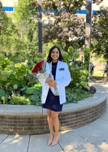 Mihika Iyer at the White Coat ceremony holding red roses, profile picture.