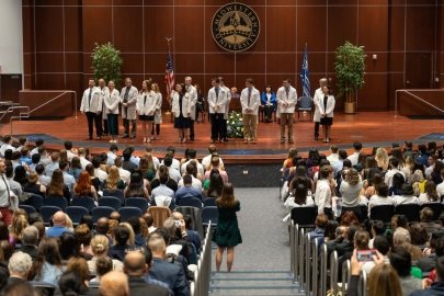 Students receive their white coats.