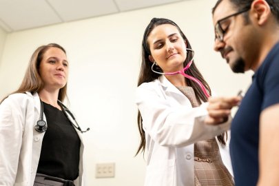 Doctor checks patient's heart