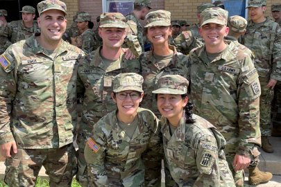 MWU student pose for photo while in military gear