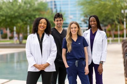 Students stand near refelecting pond