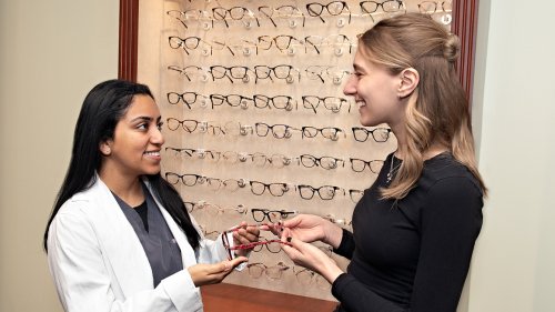 MWU Optician shows frames to a customer.