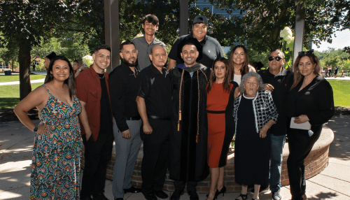 Graduate poses with his extended family at the Downers Grove campus.