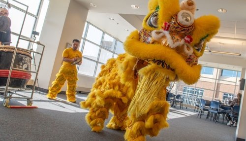 Lion dancers dressed to mark the Year of the Dragon dance in The Commons.