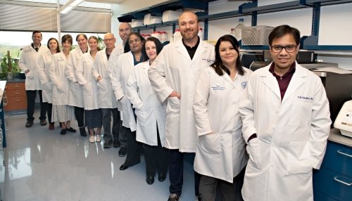 Researchers pose for a group photo in the Core Research Lab.