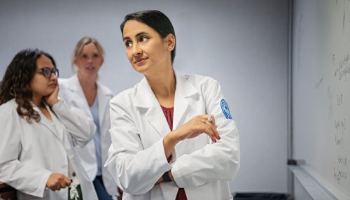 Nursing students in classroom in front of whiteboard