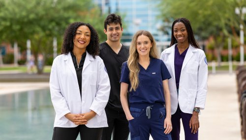 Students stand near refelecting pond