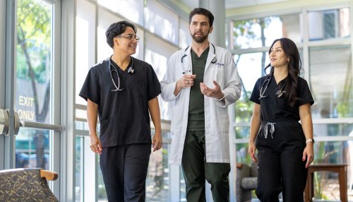 Group of doctors walking in the hallway at the Multispecialty Clinic.