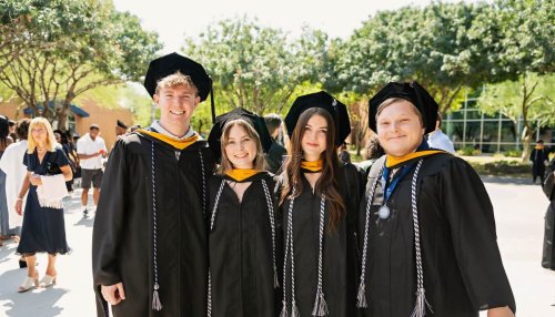 Graduates posing for camera outdoors