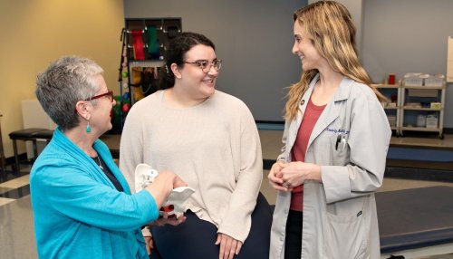 Clinicians meet with patient