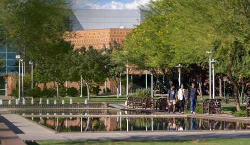 students walking near reflecting pool