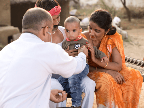 Family with young child being examined by a doctor.