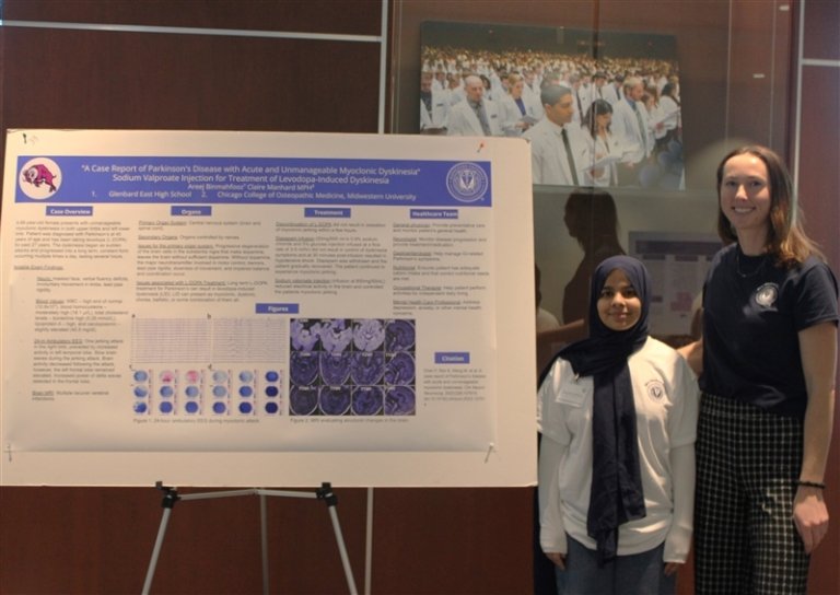 Claire Manhard and Areej Binmahfooz pose with their poster presentation.
