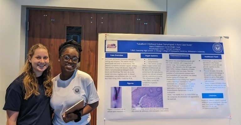 Anuoluwapo Salami and Hannah Lansberry pose with their poster presentation.