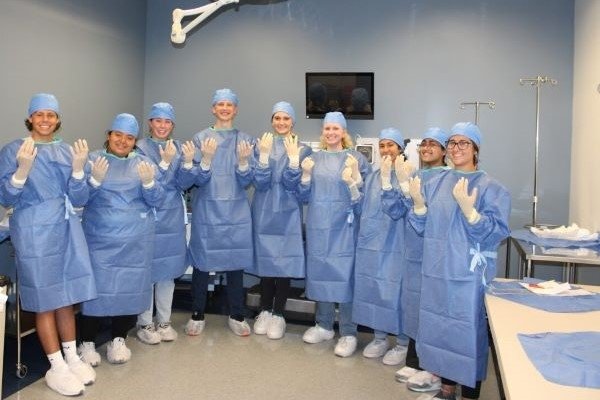 High school students scrub for surgery at the Health Careers Institute.