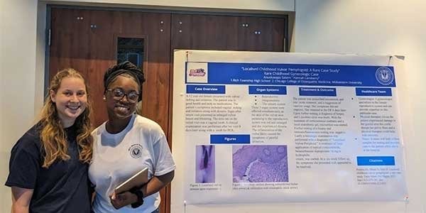 Anuoluwapo Salami and Hannah Lansberry pose with their poster presentation.