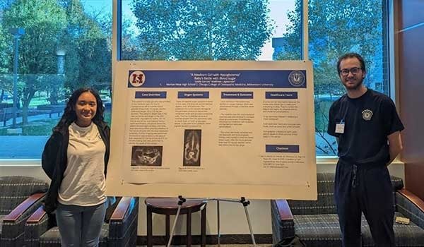 Mathew Lagerstrom and Leslie Garces pose with their poster presentation.