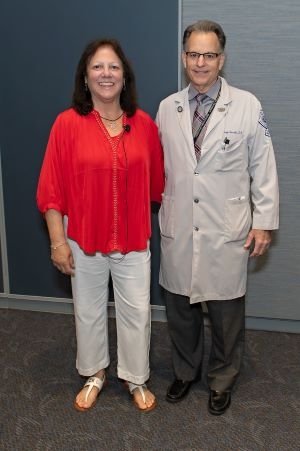 Woman and doctor pose for photo