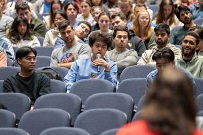 Student asks question in crowded auditorium