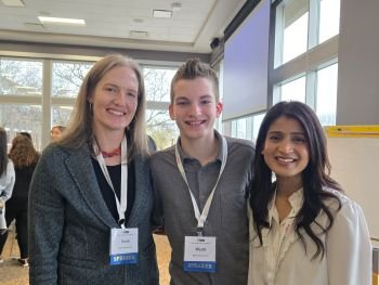 three people pose for photo