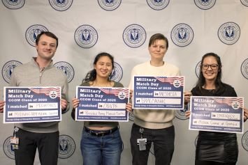 CCOM students hold up match signs