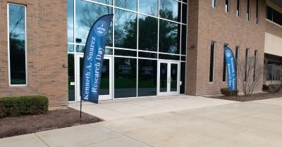 Signs annoucing Research Day stand outside Cardinal Hall
