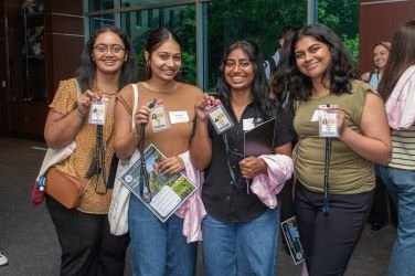 CCOM students hold ID badges