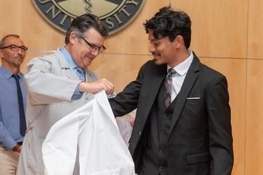 Student receives White Coat at ceremony