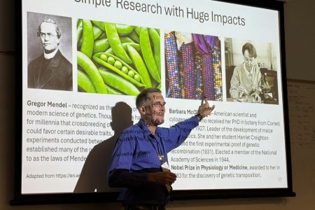Dr. Jones stands in front of his presentation about teaching the scientific process